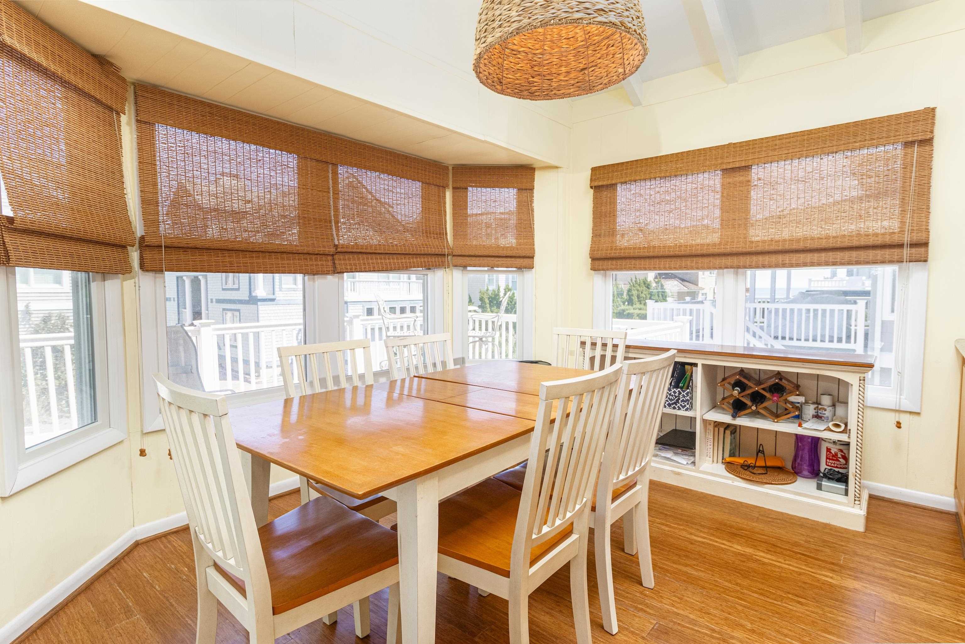 181 7th Street Avalon, NJ 08202 - Photo 15 of 29 a dining room with furniture a chandelier and wooden floor
