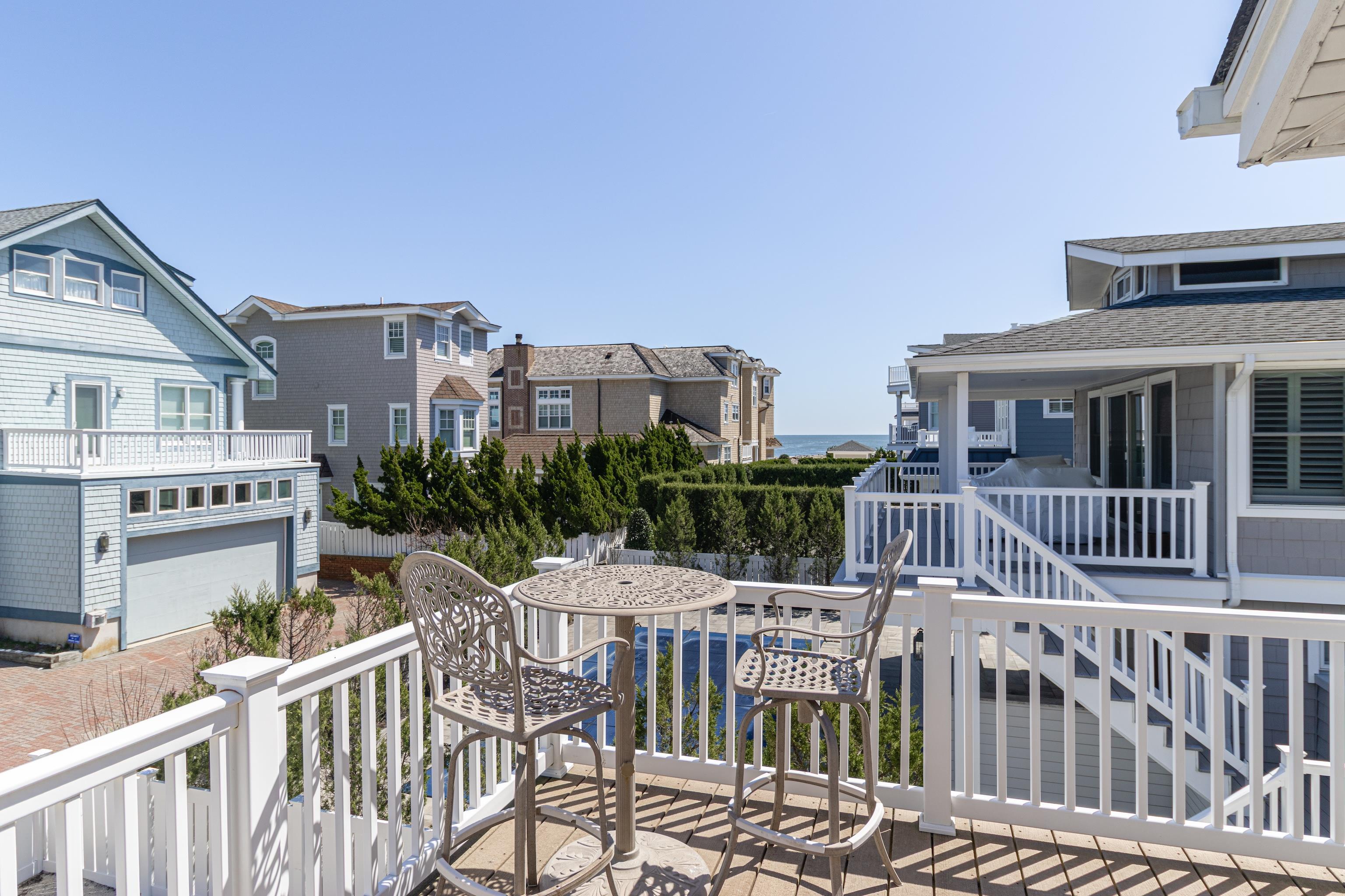 181 7th Street Avalon, NJ 08202 - Photo 19 of 29 a view of a roof deck with table and chairs