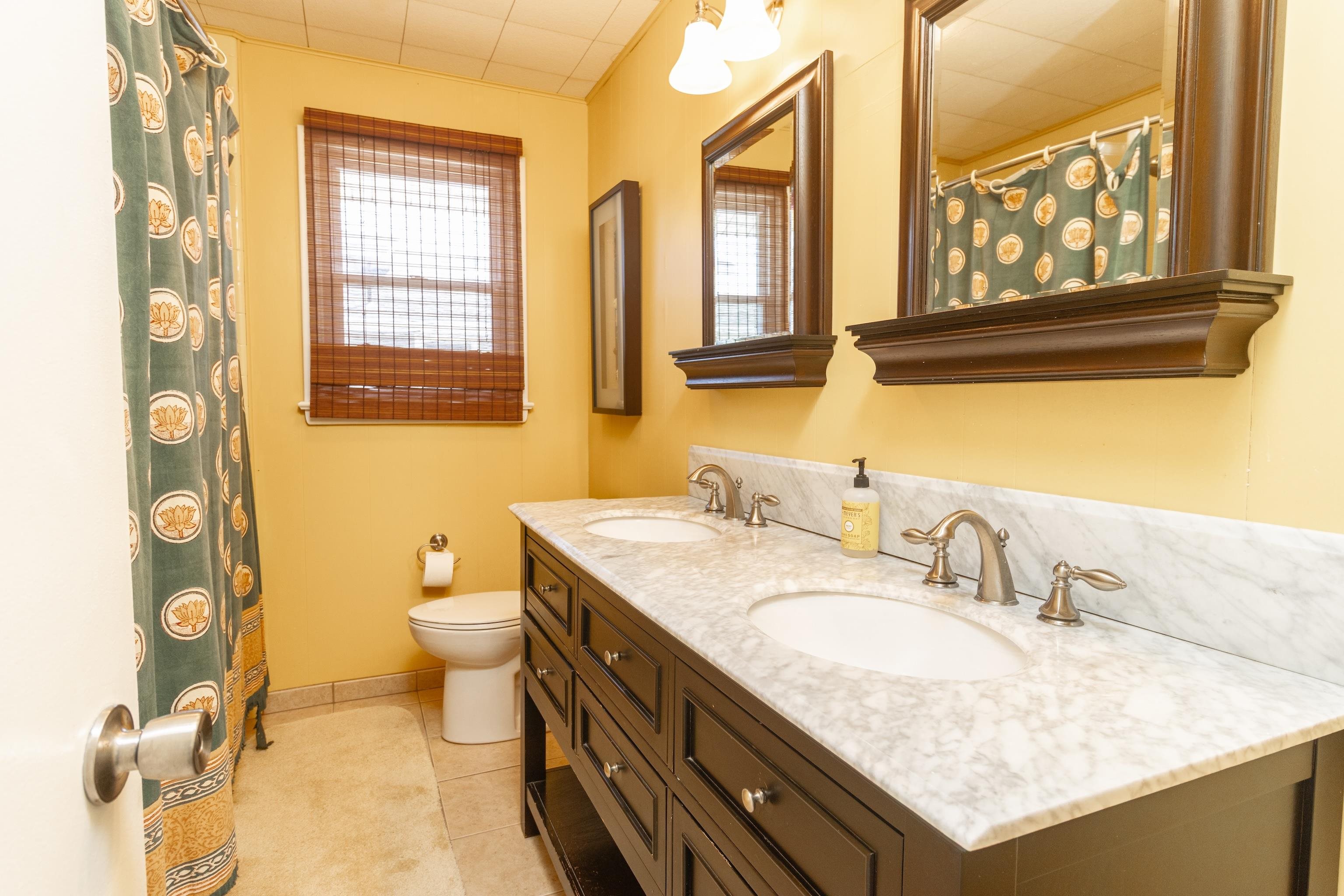 181 7th Street Avalon, NJ 08202 - Photo 21 of 29 a bathroom with a granite countertop sink and a mirror