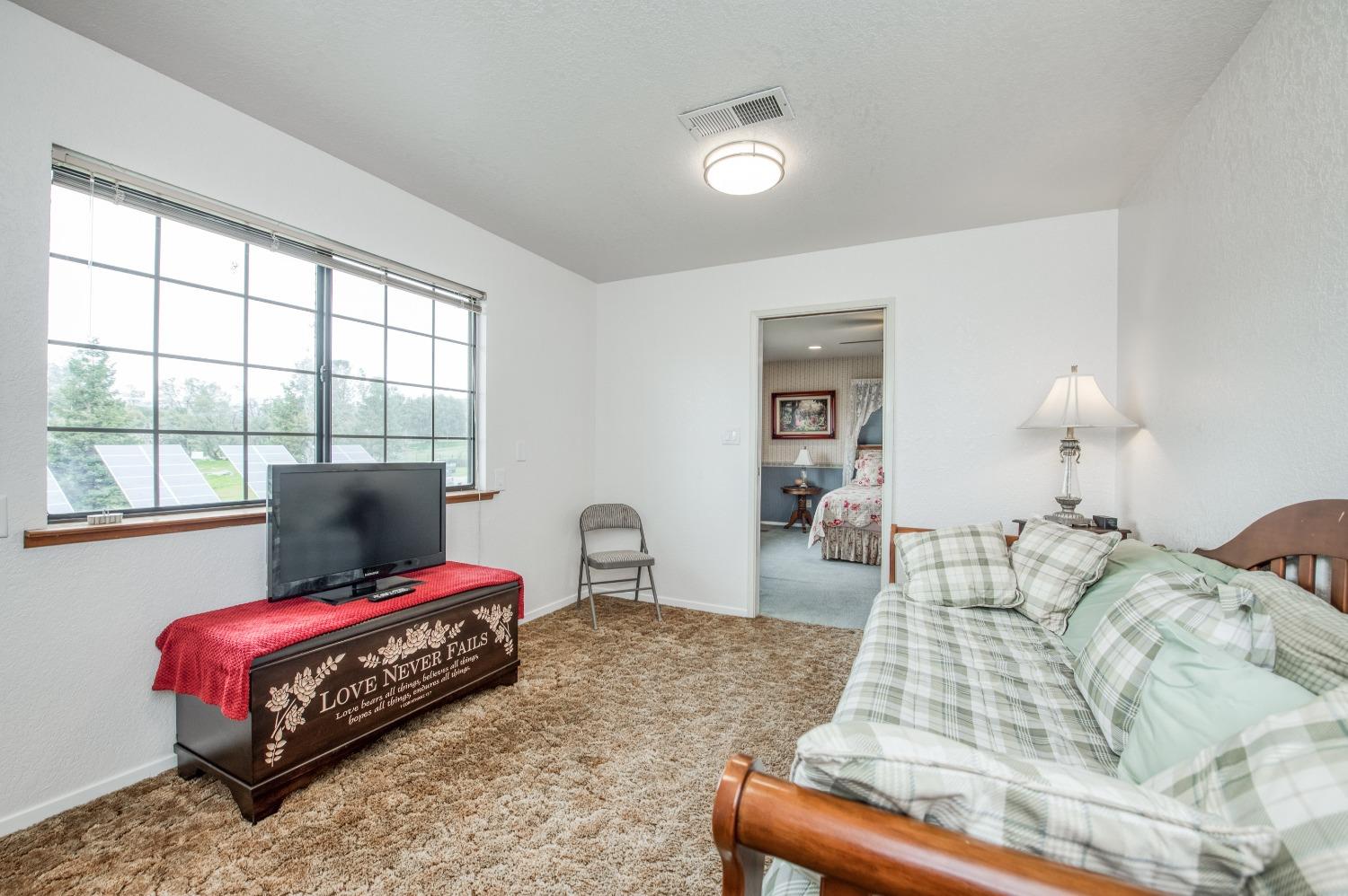 30128 Auberry Road Prather, CA 93651 - Photo 15 of 99 a bedroom with a bed and wooden floor