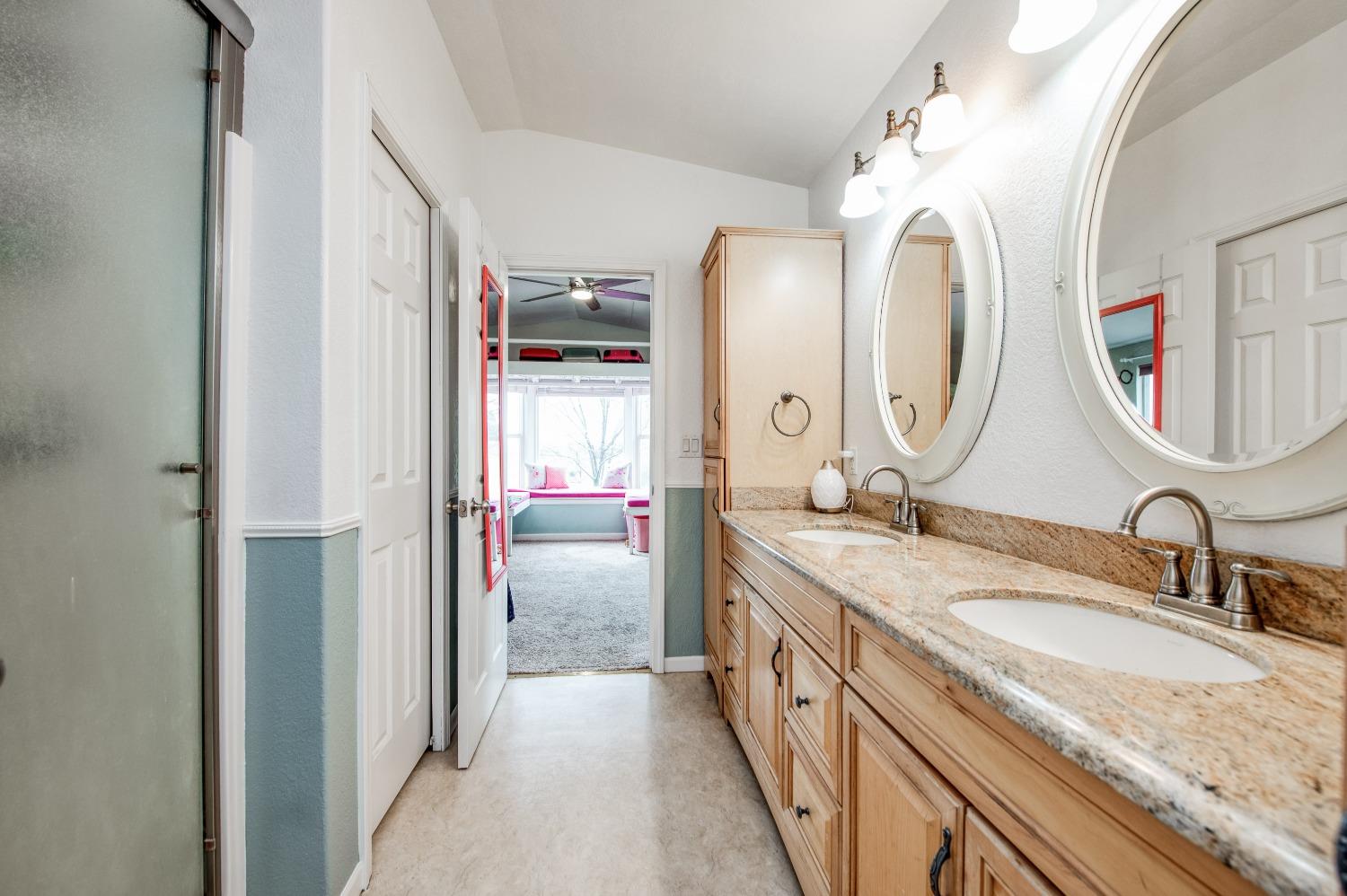 30128 Auberry Road Prather, CA 93651 - Photo 34 of 99 a en suite bathroom with a granite countertop double vanity sink and a mirror