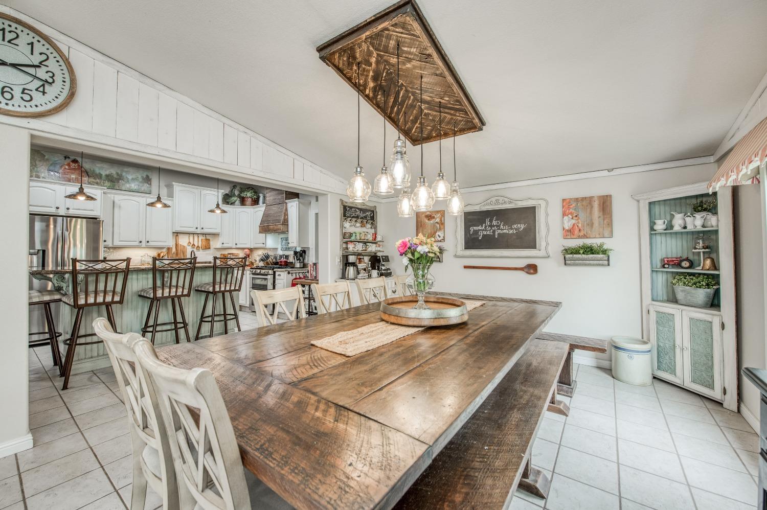 30128 Auberry Road Prather, CA 93651 - Photo 51 of 99 a kitchen with stainless steel appliances wooden floor dining table and chairs