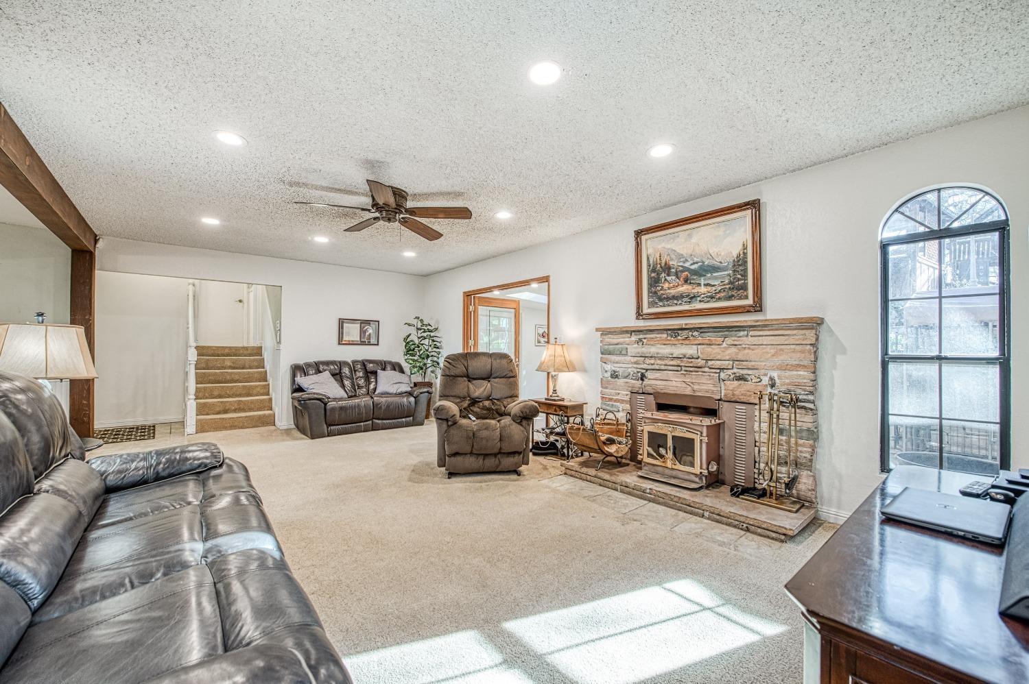 30128 Auberry Road Prather, CA 93651 - Photo 6 of 99 a living room with furniture a fireplace and a chandelier