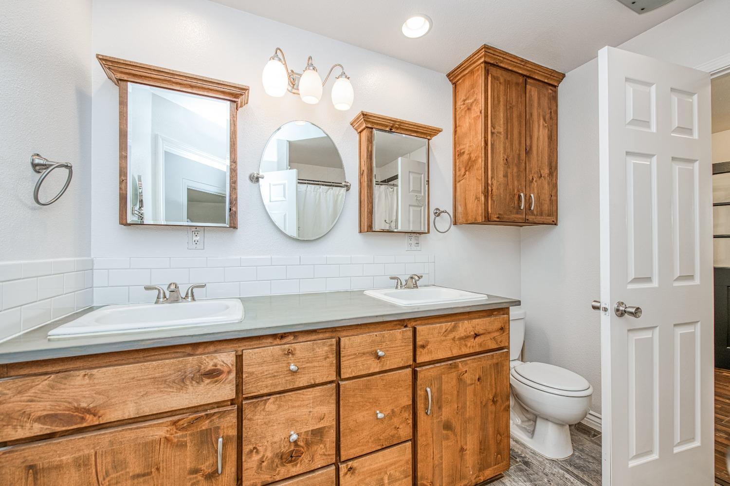 30128 Auberry Road Prather, CA 93651 - Photo 65 of 99 a bathroom with a toilet sink and mirror