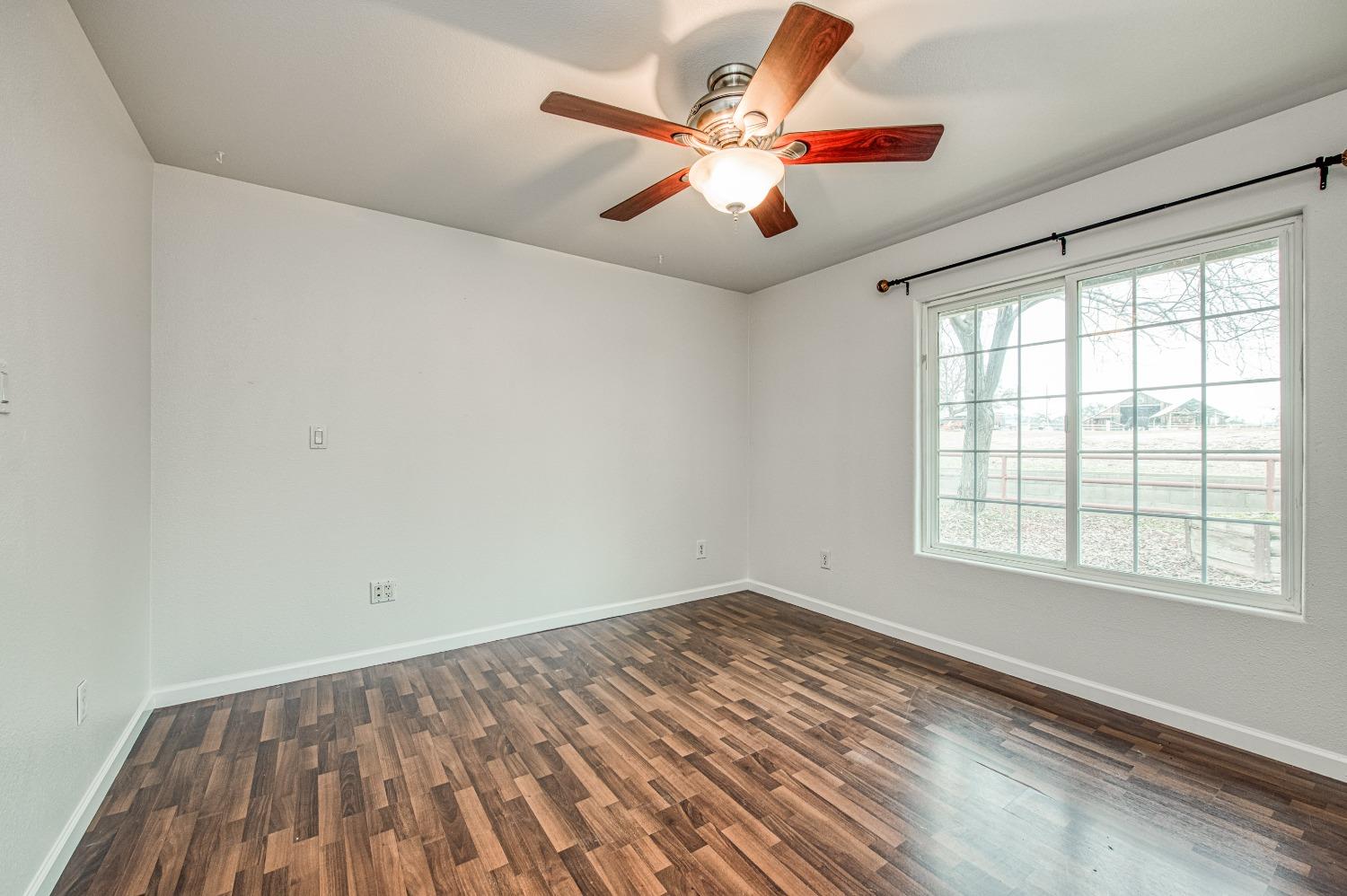 30128 Auberry Road Prather, CA 93651 - Photo 66 of 99 an empty room with wooden floor and windows