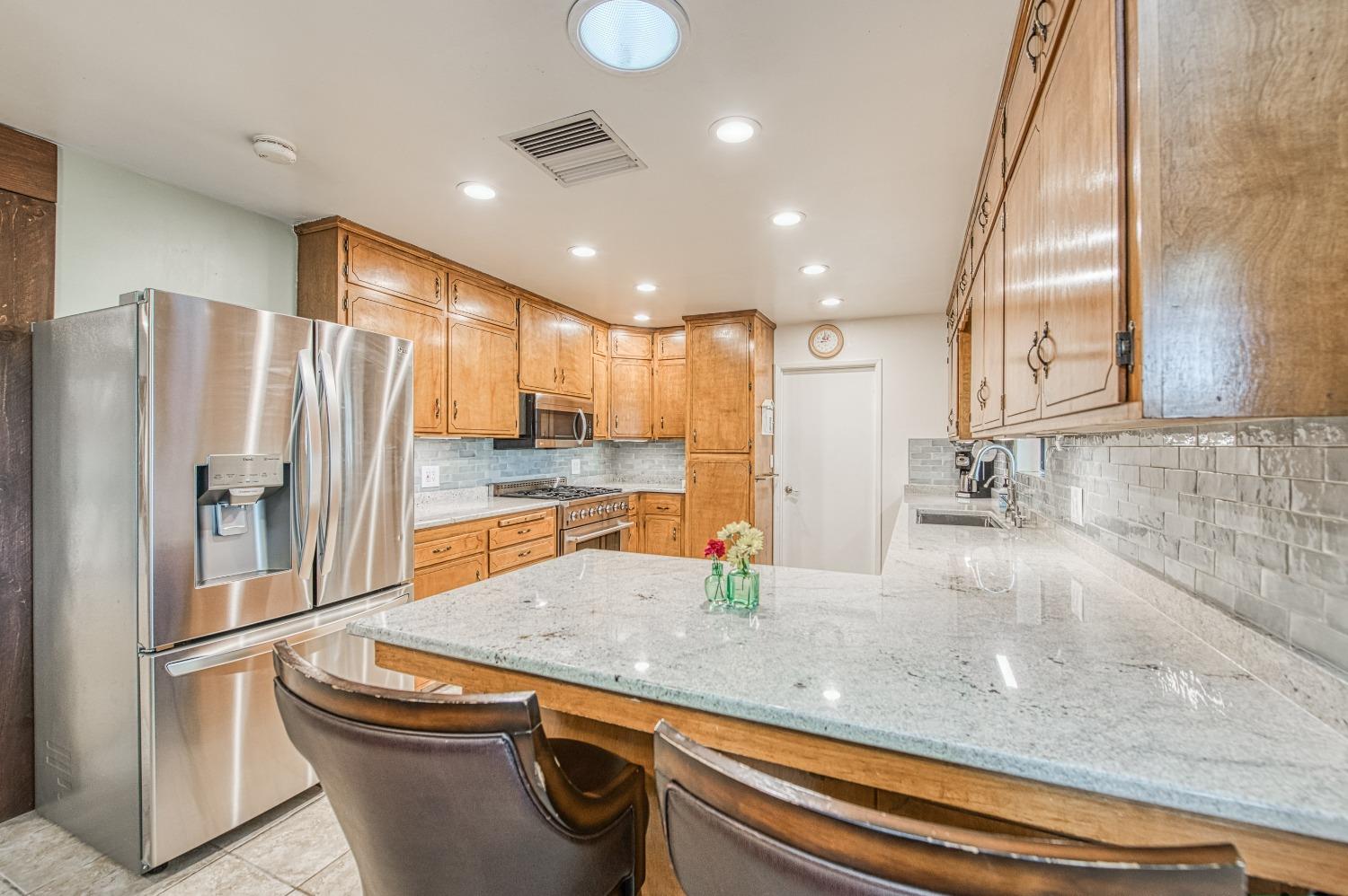 30128 Auberry Road Prather, CA 93651 - Photo 10 of 99 a kitchen with stainless steel appliances granite countertop a refrigerator a sink and a stove
