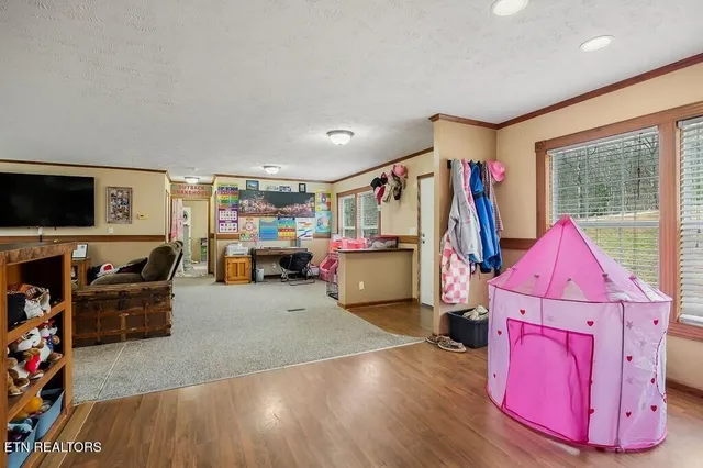 a front view of a house with a yard and seating space