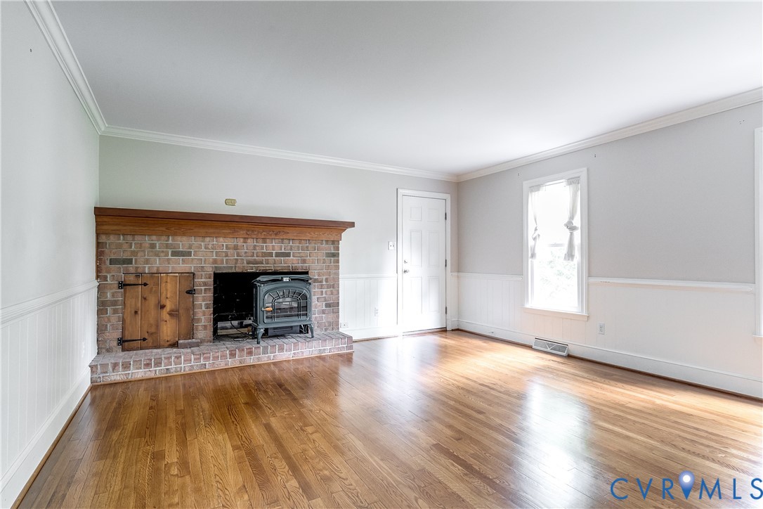 3924 Belspring Road Chester, VA 23831 - Photo 32 of 36 Spacious room featuring a brick fireplace with a w
