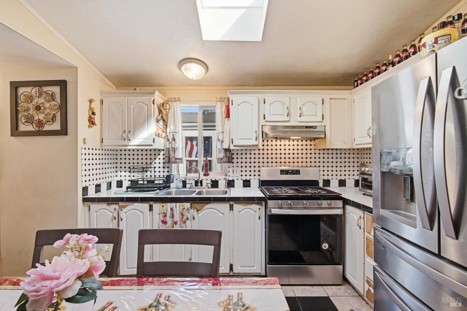 2963 Santa Rosa Avenue, Unit B2 Santa Rosa, CA 95407 - Photo 11 of 32 a kitchen with stainless steel appliances granite countertop a stove and a refrigerator