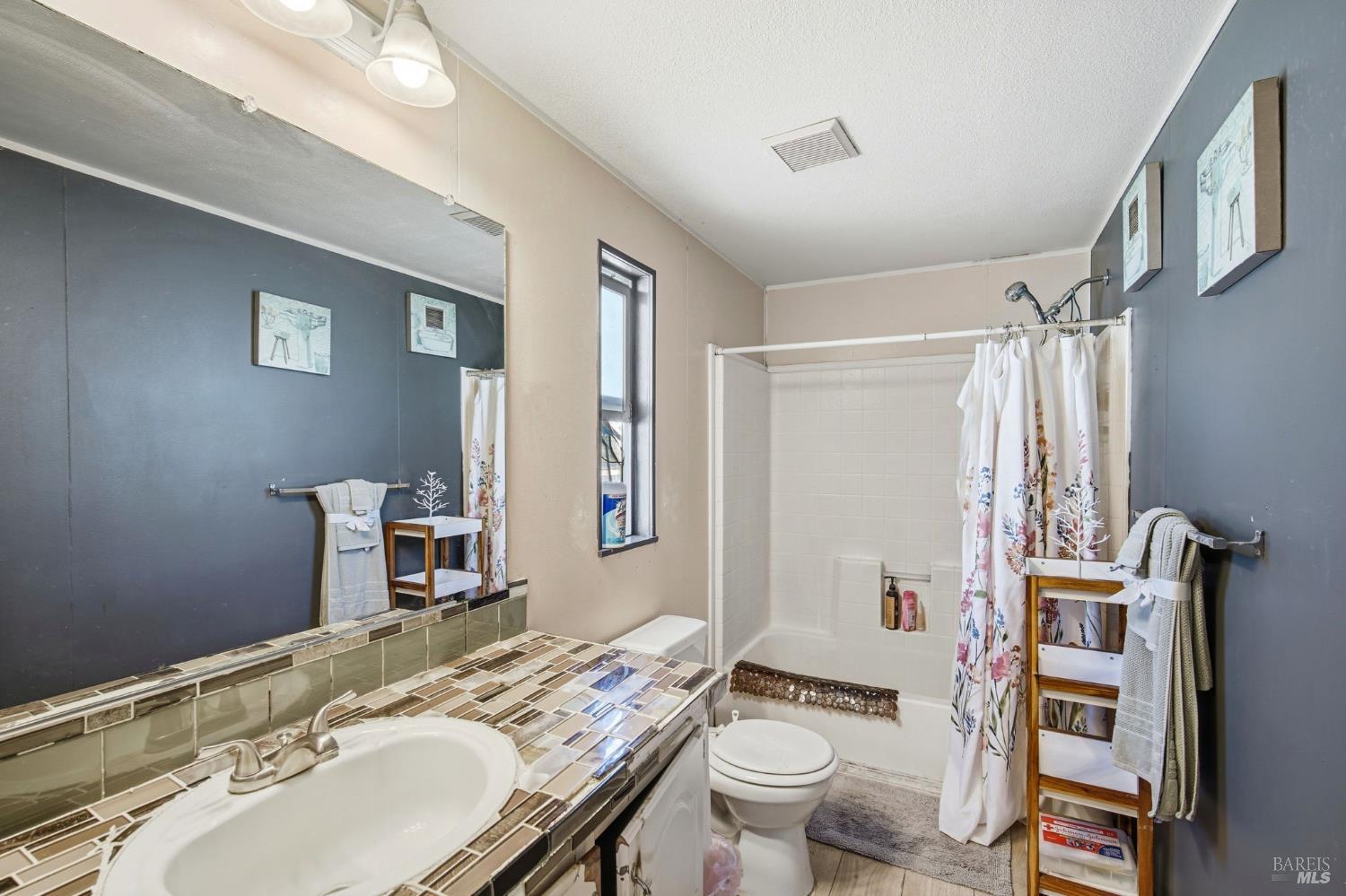 2963 Santa Rosa Avenue, Unit B2 Santa Rosa, CA 95407 - Photo 25 of 32 a bathroom with a sink toilet vanity and shower