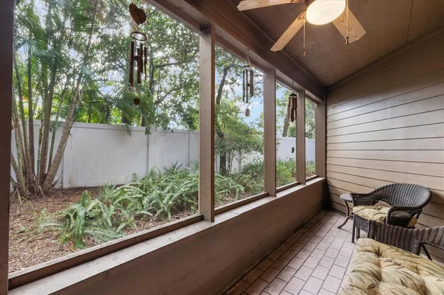 a balcony with chairs and a table