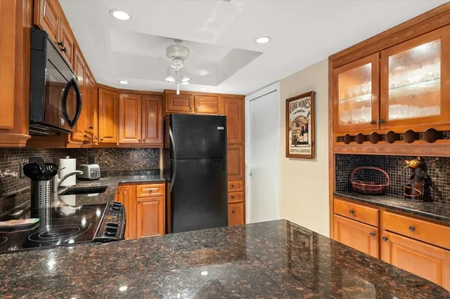 a kitchen with stainless steel appliances granite countertop a refrigerator and a sink