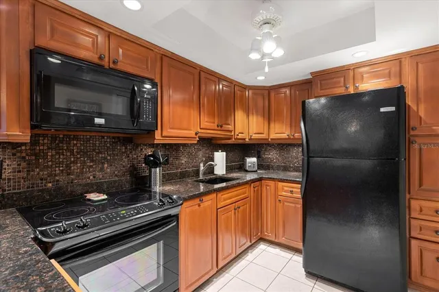a kitchen with stainless steel appliances granite countertop a stove microwave and refrigerator