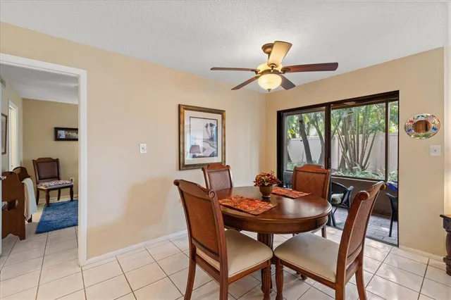 a view of a dining room with furniture and a chandelier