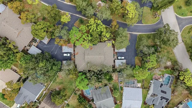 an aerial view of a house with a yard and lake view