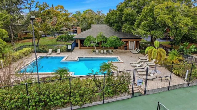 a view of a swimming pool with lounge chairs