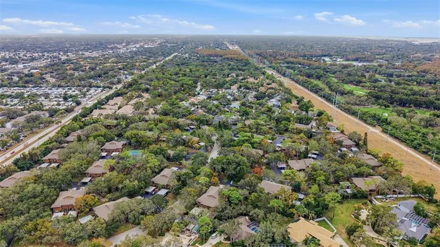 a sign that is next to a tree