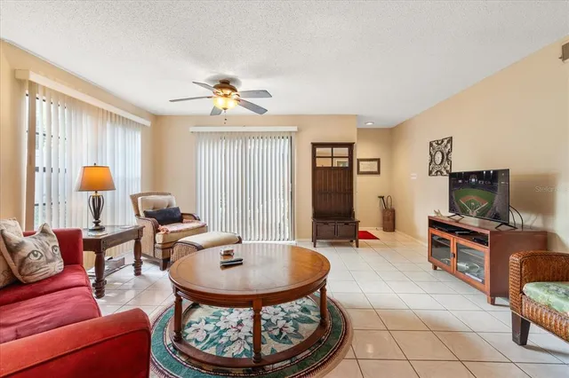 a living room with furniture a dining table and a flat screen tv