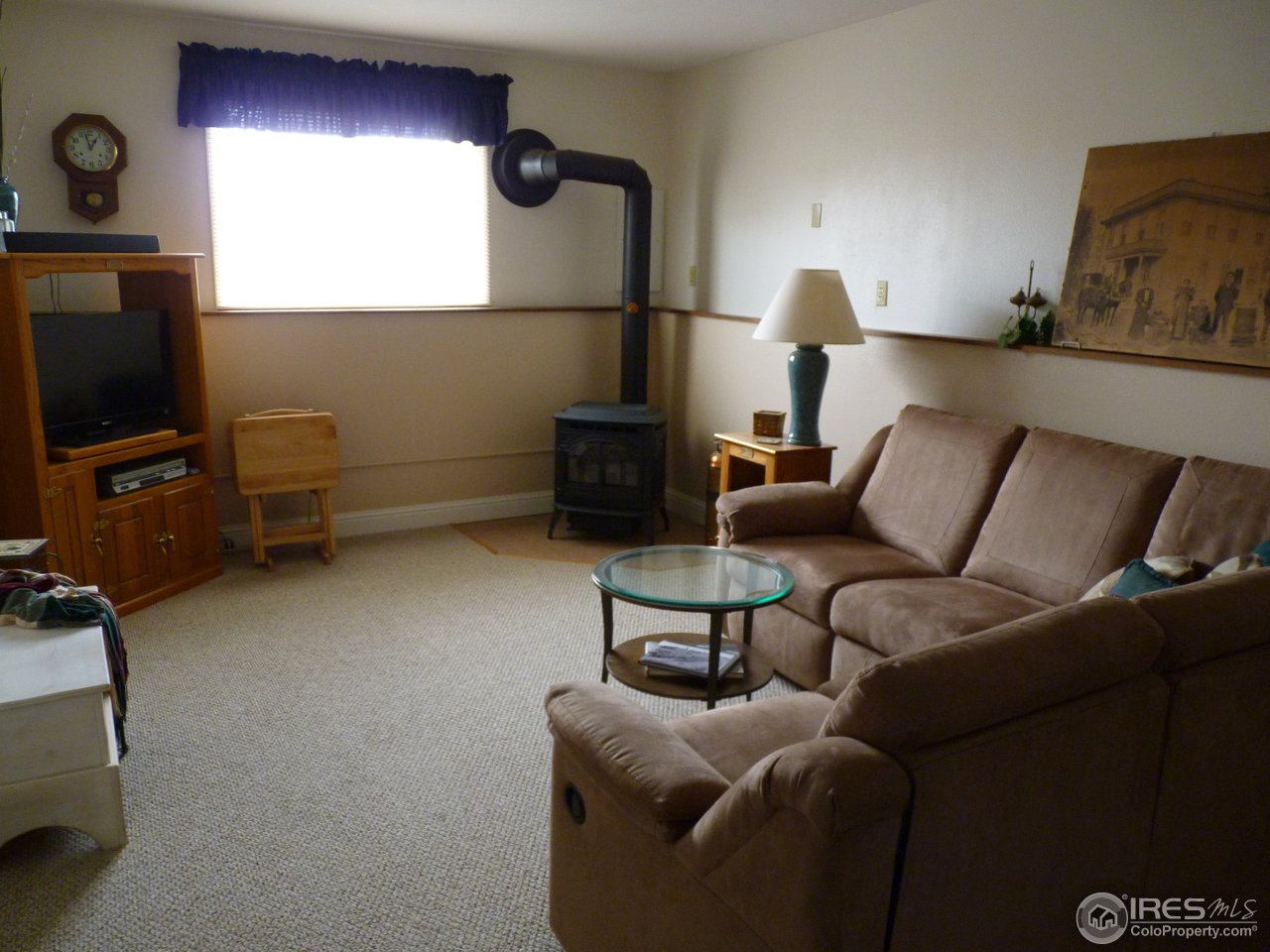 813 Gould Road Berthoud, CO 80513 - Photo 16 of 25 Family Room w/Pellet Stove