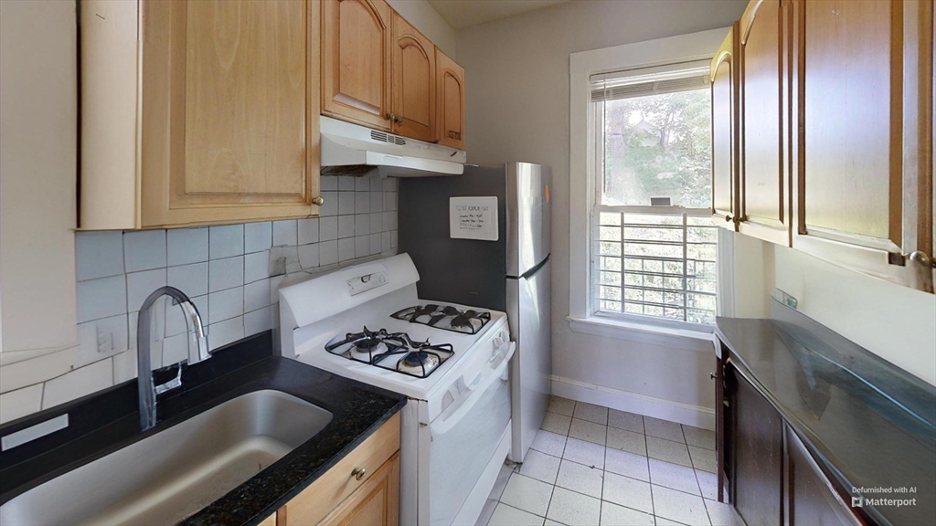 1789 Commonwealth Avenue, Unit 2 Boston, MA 02135 - Photo 1 of 16 a kitchen with stainless steel appliances granite countertop a sink stove and cabinets