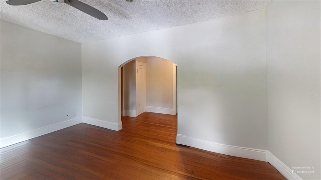 1789 Commonwealth Avenue, Unit 2 Boston, MA 02135 - Photo 11 of 16 a view of an empty room with wooden floor