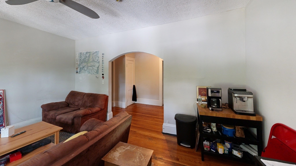 1789 Commonwealth Avenue, Unit 2 Boston, MA 02135 - Photo 12 of 16 a living room with furniture and a wooden floor