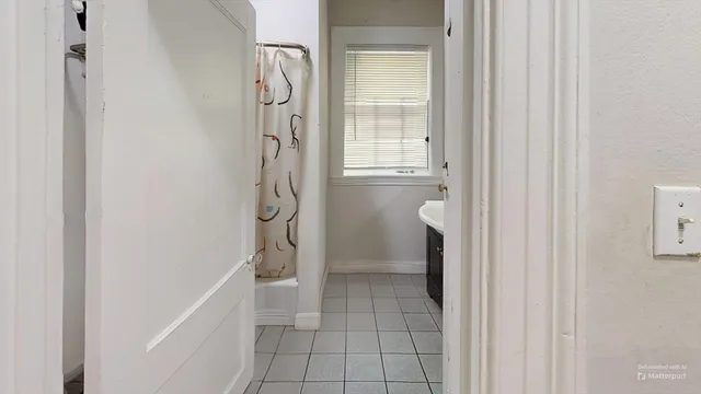 a bathroom with a granite countertop shower and a toilet