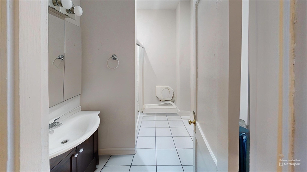 1789 Commonwealth Avenue, Unit 2 Boston, MA 02135 - Photo 16 of 16 a bathroom with a sink toilet and vanity