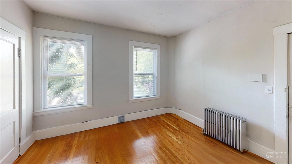1789 Commonwealth Avenue, Unit 2 Boston, MA 02135 - Photo 3 of 16 a view of empty room with wooden floor and fan
