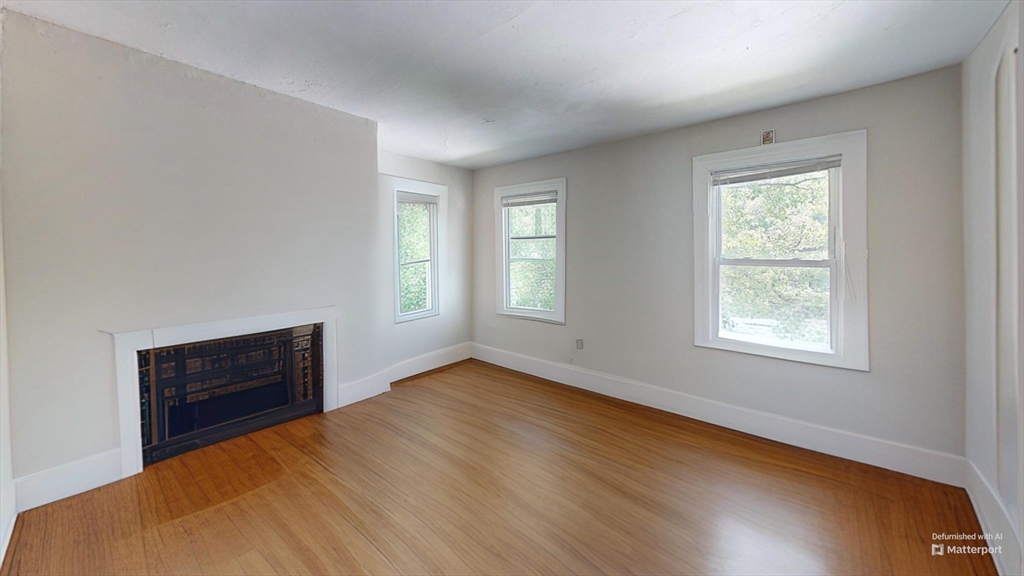 1789 Commonwealth Avenue, Unit 2 Boston, MA 02135 - Photo 7 of 16 a view of an empty room with wooden floor and a window