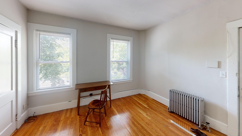 1789 Commonwealth Avenue, Unit 2 Boston, MA 02135 - Photo 9 of 16 a room with wooden floor and a window