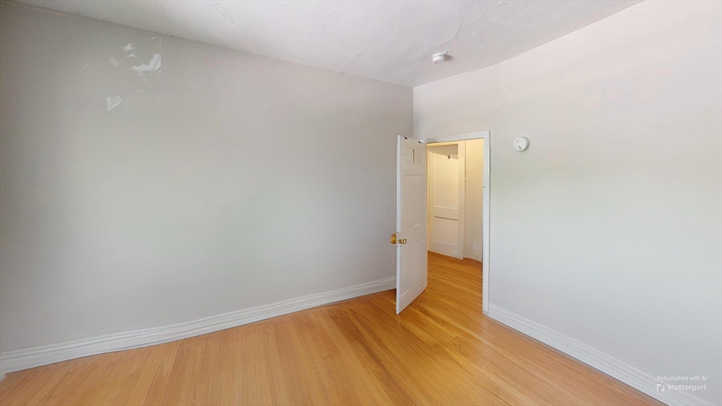 1789 Commonwealth Avenue, Unit 2 Boston, MA 02135 - Photo 10 of 16 a view of empty room with wooden floor