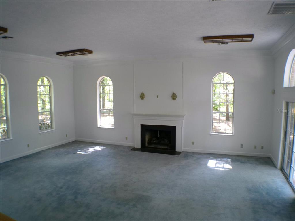 415 Southeast 123rd Street Road Ocala, FL 34480 - Photo 16 of 50 a view of empty room with a fireplace
