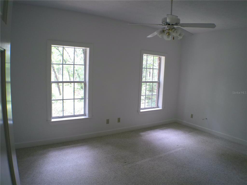 415 Southeast 123rd Street Road Ocala, FL 34480 - Photo 29 of 50 an empty room with a window and a fan