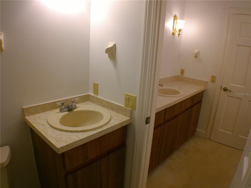 415 Southeast 123rd Street Road Ocala, FL 34480 - Photo 30 of 50 a bathroom with a sink and a mirror