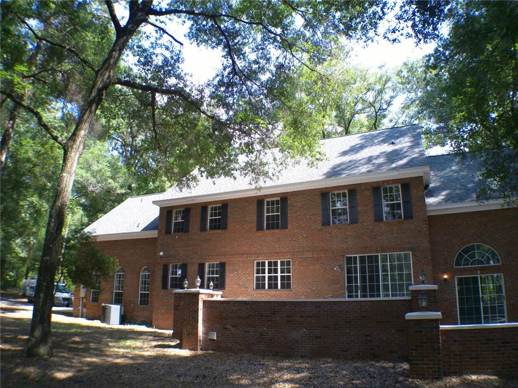 415 Southeast 123rd Street Road Ocala, FL 34480 - Photo 36 of 50 a front view of a house with a garden