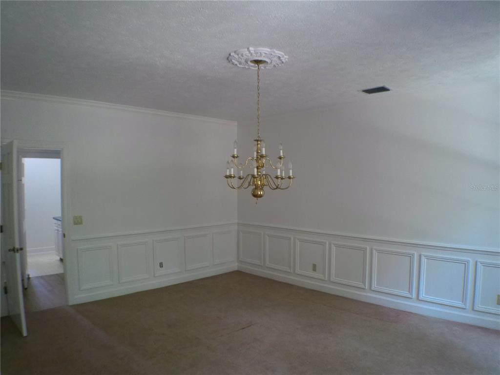 415 Southeast 123rd Street Road Ocala, FL 34480 - Photo 9 of 50 a view of an empty room with chandelier fan