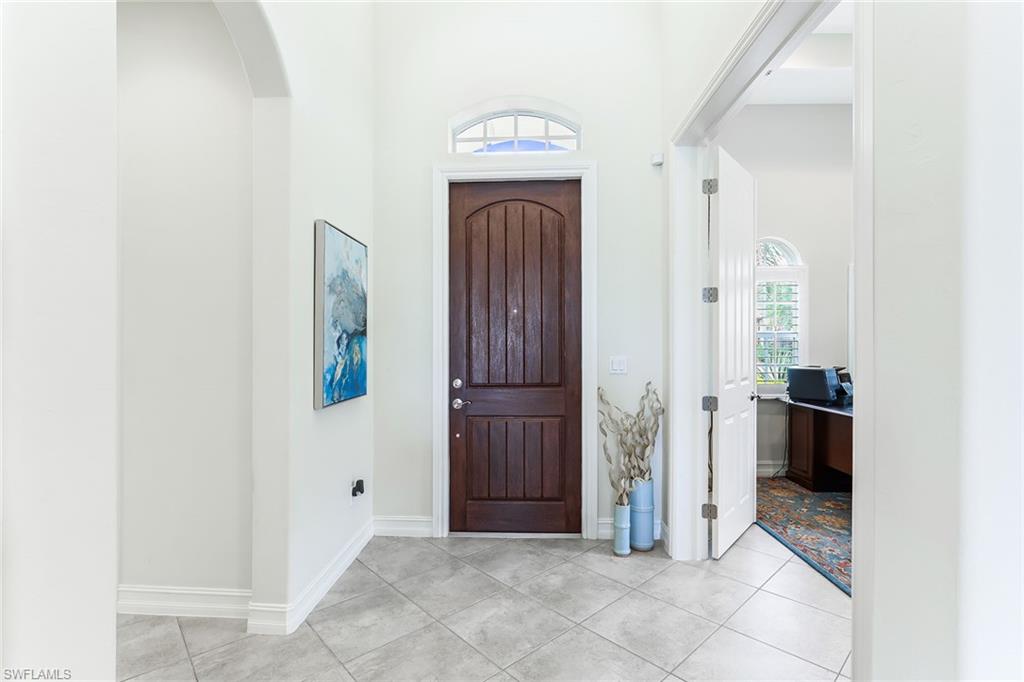 6581 Caldecott Drive Naples, FL 34113 - Photo 11 of 34 a view of entryway with wooden floor