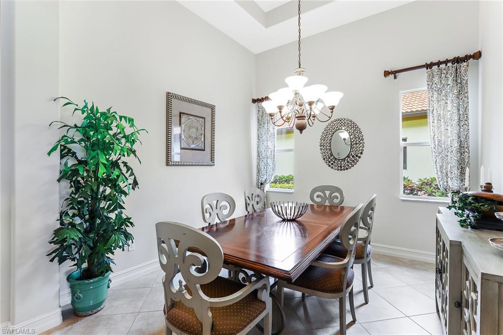 6581 Caldecott Drive Naples, FL 34113 - Photo 13 of 34 a view of a dining room with furniture and chandelier