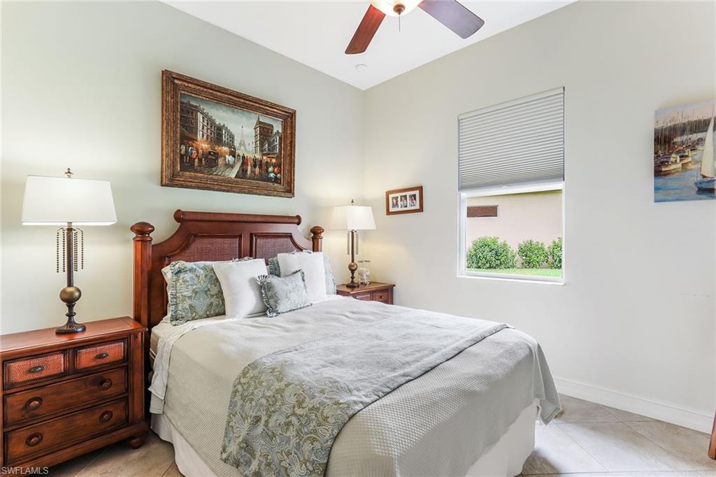 6581 Caldecott Drive Naples, FL 34113 - Photo 23 of 34 a bedroom with a bed and a painting on the wall