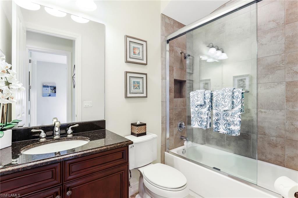 6581 Caldecott Drive Naples, FL 34113 - Photo 24 of 34 a bathroom with a granite countertop sink toilet tub and shower