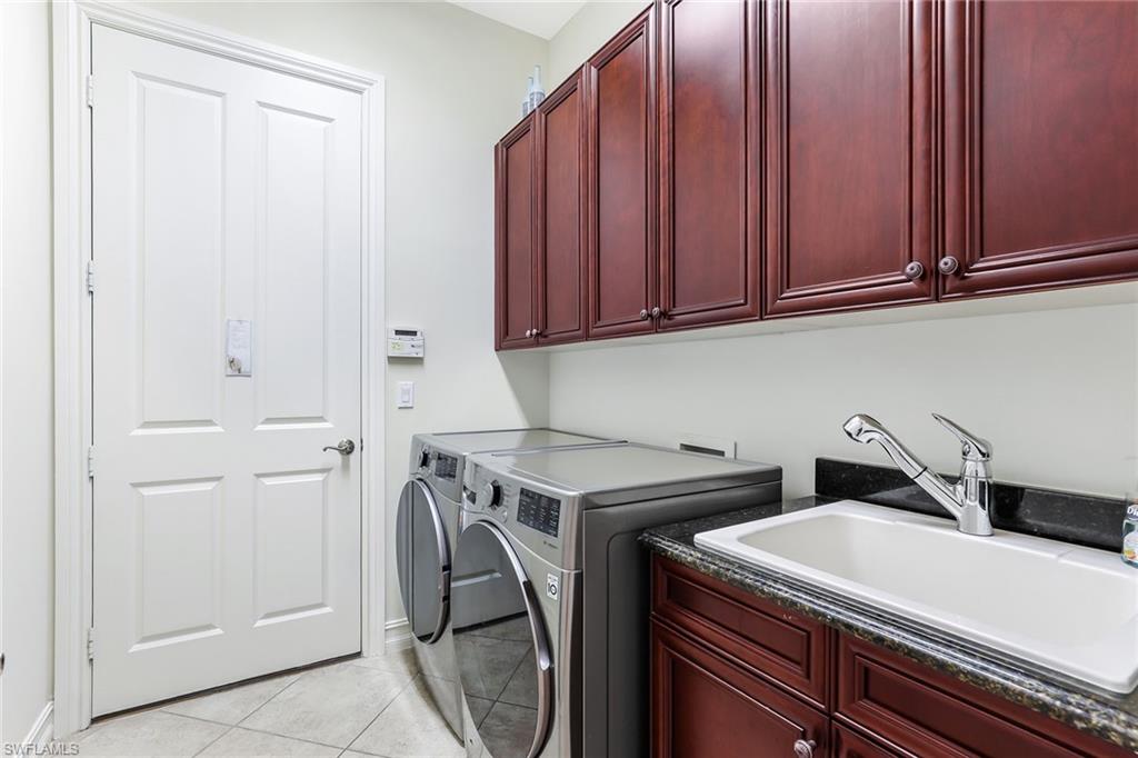 6581 Caldecott Drive Naples, FL 34113 - Photo 26 of 34 a utility room with dryer and washer