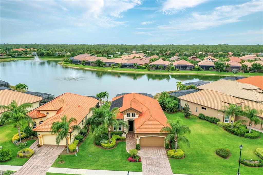 6581 Caldecott Drive Naples, FL 34113 - Photo 4 of 34 an aerial view of a house with a garden and lake view