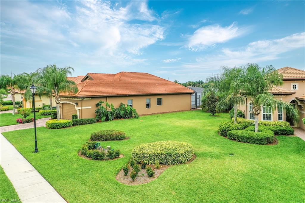 6581 Caldecott Drive Naples, FL 34113 - Photo 8 of 34 a view of a house with a big yard plants and large trees