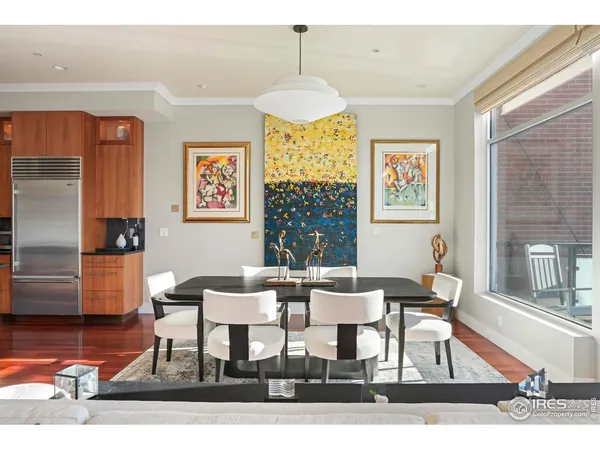 a living room with furniture kitchen view and a large window
