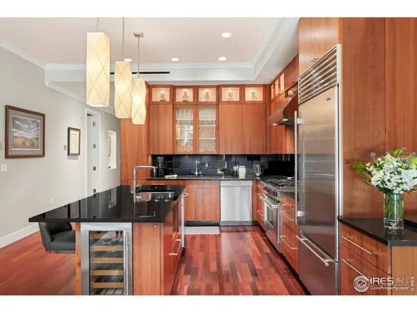 a living room with furniture a large window and appliances