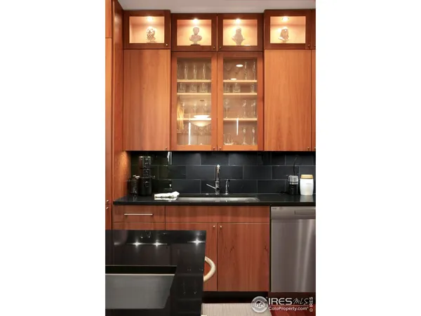 a kitchen with kitchen island granite countertop wooden cabinets and a refrigerator
