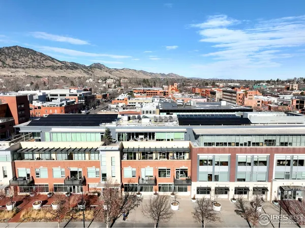 a living room with furniture a flat screen tv and a large window
