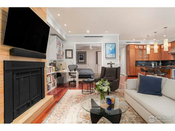 a living room with furniture a flat screen tv and a fireplace