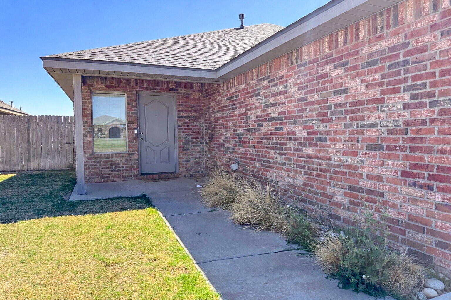 a view of front door of a house with a yard